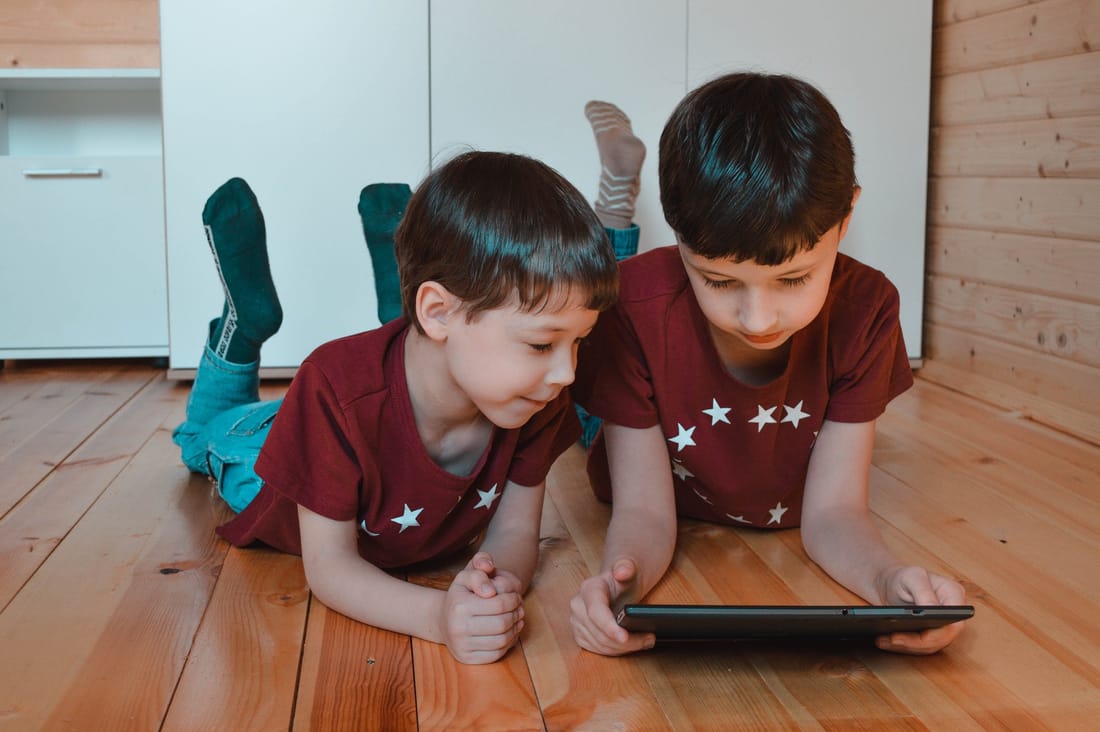 Two boys staring at tablet computer